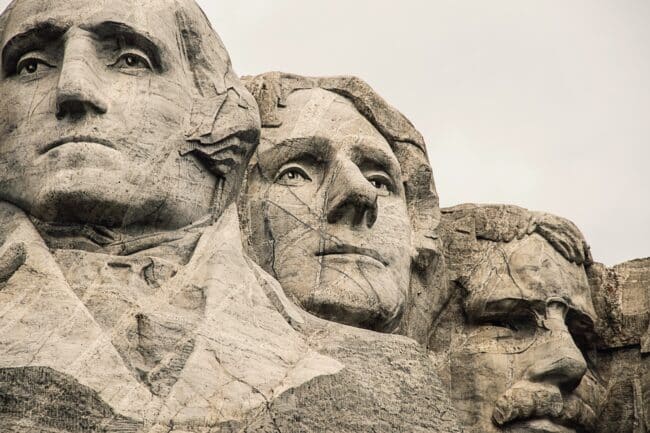 A stylized portrait of the Founding Fathers at Mount Rushmore